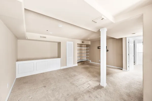 a view of an empty room with a cabinet and a shower