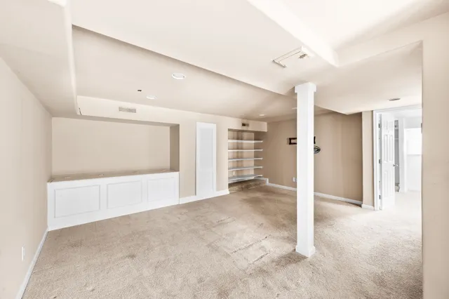 a view of an empty room with a cabinet and a shower