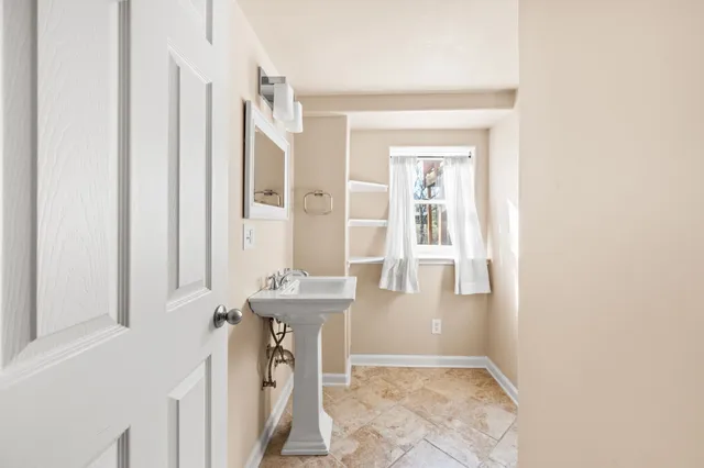 a bathroom with a sink a mirror and a bathtub