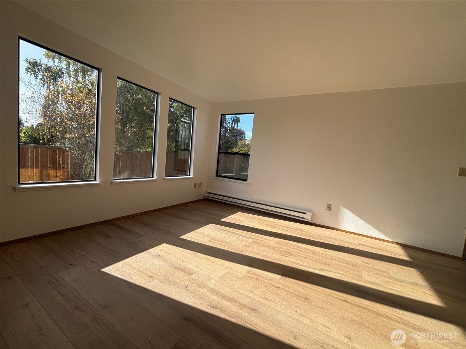 2638 Cascade Trail, Unit A Bremerton, WA 98310 - Photo 3 of 13 a view of an empty room with wooden floor and a window