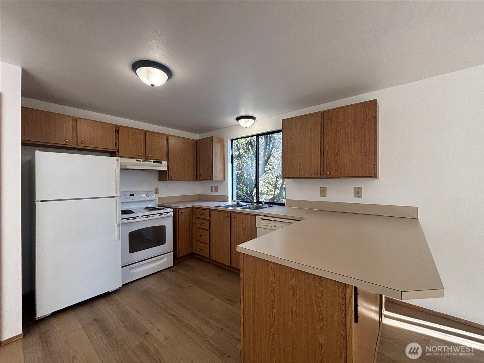 2638 Cascade Trail, Unit A Bremerton, WA 98310 - Photo 6 of 13 a kitchen with a white cabinets and white appliances