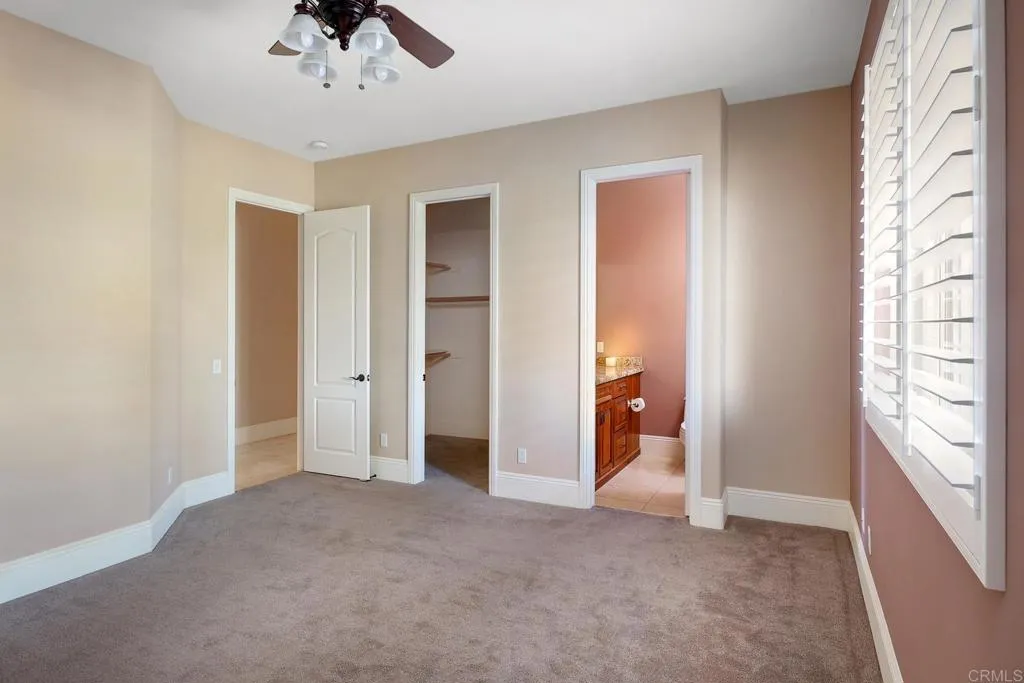 14748 Cool Valley Ranch Road Valley Center, CA 92082 - Photo 17 of 30 a view of empty room with wooden floor and fan