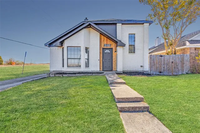 a view of a house with a yard and porch