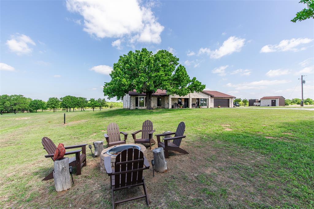 2043 Huddleston Road Sunset, TX 76270 - Photo 21 of 36 a view of a lake with table and chairs under an umbrella