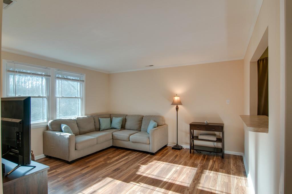 7709 Chester Road Fairview, TN 37062 - Photo 11 of 29 a living room with furniture and a fireplace