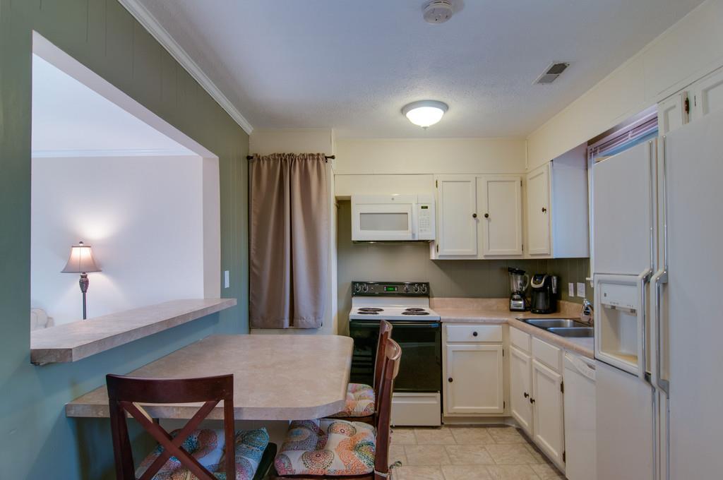 7709 Chester Road Fairview, TN 37062 - Photo 14 of 29 a kitchen with a stove a sink and a refrigerator