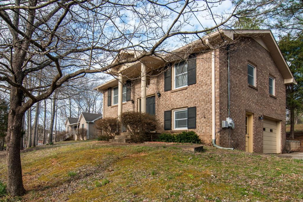 7709 Chester Road Fairview, TN 37062 - Photo 2 of 29 a view of a yard in front of a house with a large tree
