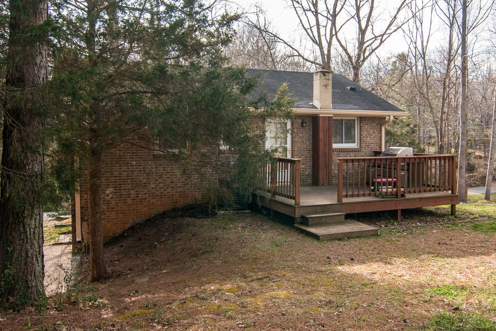 7709 Chester Road Fairview, TN 37062 - Photo 23 of 29 a view of a house with a yard balcony and wooden fence