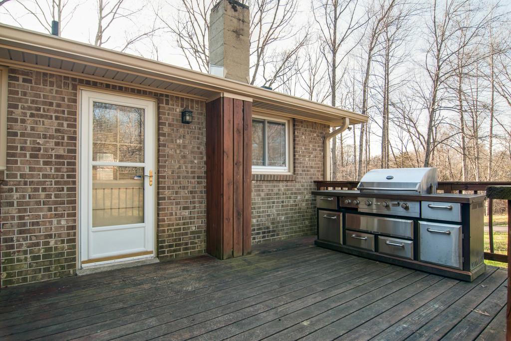 7709 Chester Road Fairview, TN 37062 - Photo 25 of 29 a view of a house with a yard and wooden deck