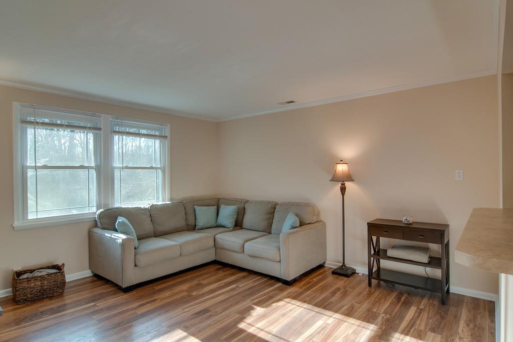 7709 Chester Road Fairview, TN 37062 - Photo 8 of 29 a living room with furniture a wooden floor and a window