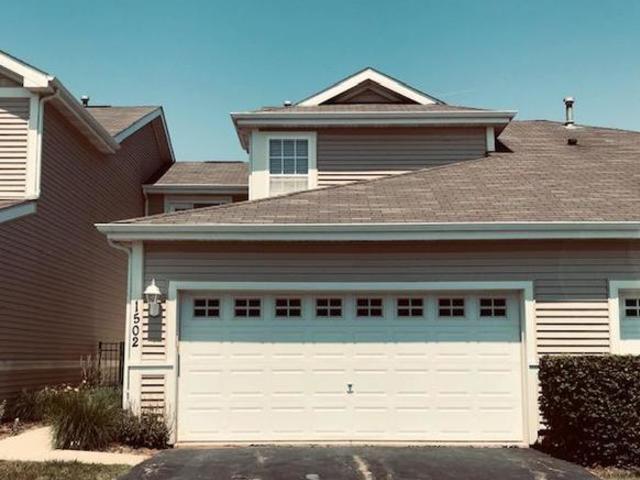 1502 Remington Lane Round Lake, IL 60073 - Photo 1 of 29 a front view of a house with a garage