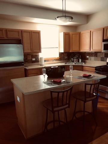 1502 Remington Lane Round Lake, IL 60073 - Photo 8 of 29 a kitchen with a stove a sink and a microwave
