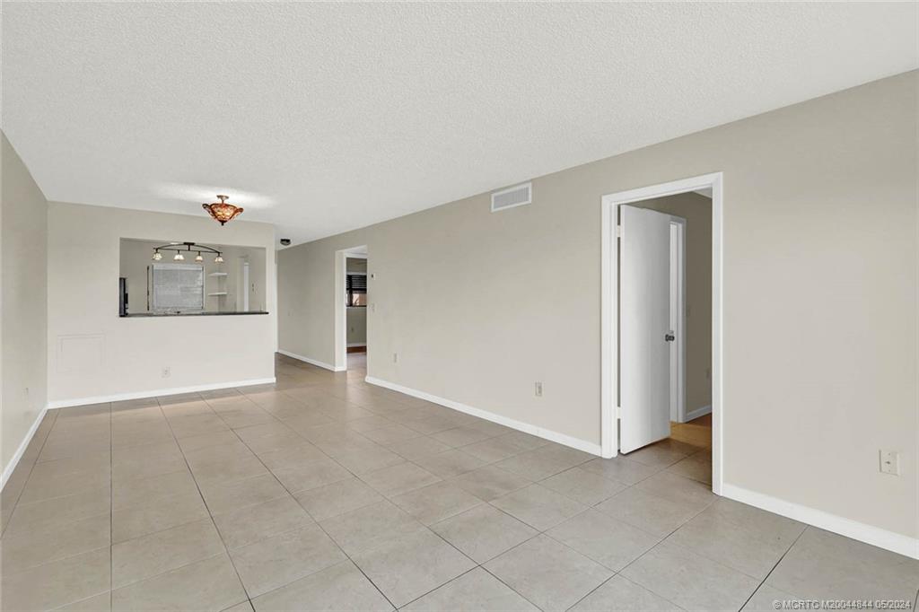 7400 South Ocean Drive, Unit 102 Jensen Beach, FL 34957 - Photo 11 of 26 a view of an empty room with a window