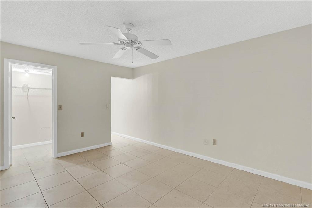 7400 South Ocean Drive, Unit 102 Jensen Beach, FL 34957 - Photo 15 of 26 an empty room with a ceiling fan and a window