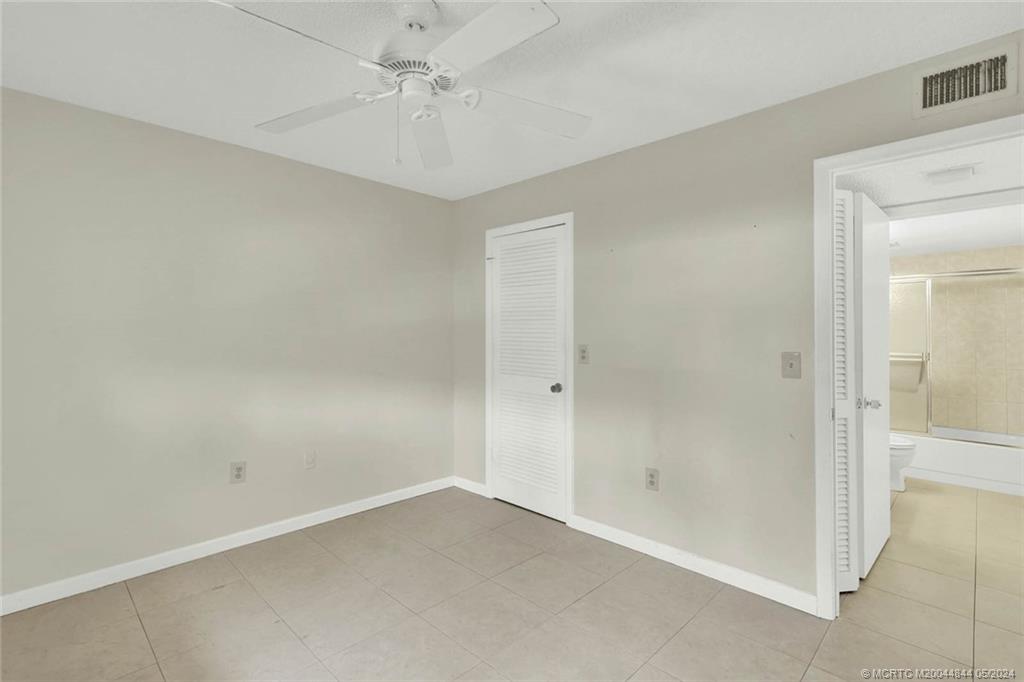 7400 South Ocean Drive, Unit 102 Jensen Beach, FL 34957 - Photo 22 of 26 an empty room with a ceiling fan and a window