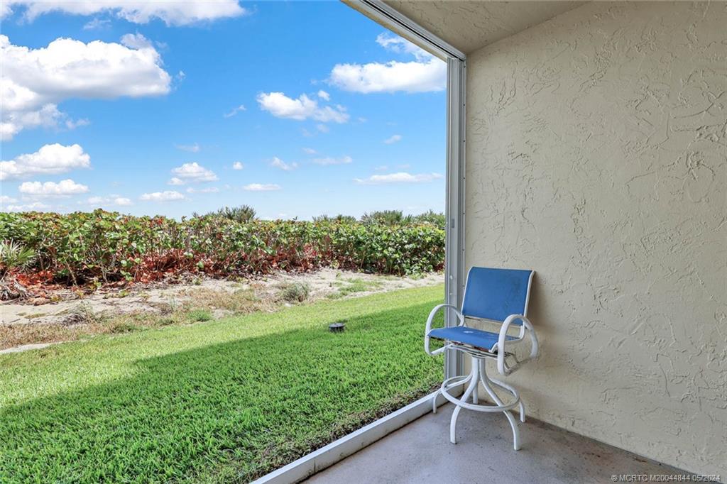 7400 South Ocean Drive, Unit 102 Jensen Beach, FL 34957 - Photo 5 of 26 a view of a backyard with sitting area