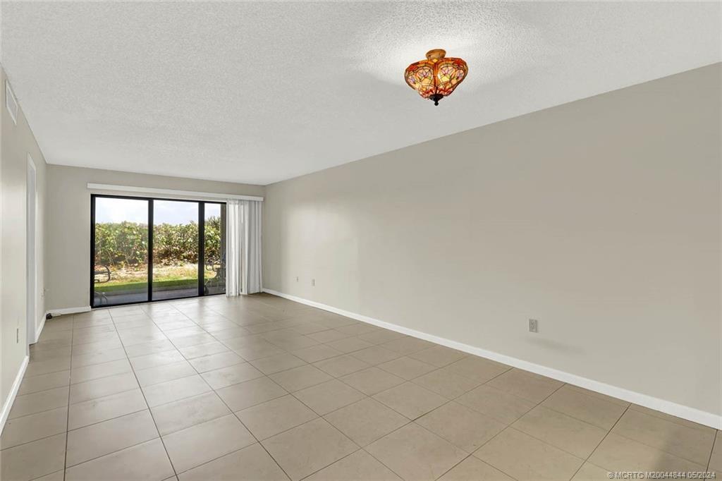 7400 South Ocean Drive, Unit 102 Jensen Beach, FL 34957 - Photo 9 of 26 a view of an empty room and window