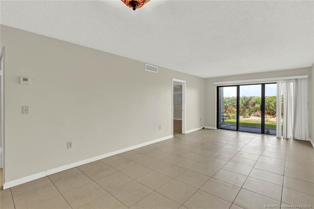 7400 South Ocean Drive, Unit 102 Jensen Beach, FL 34957 - Photo 10 of 26 a view of an empty room with a window
