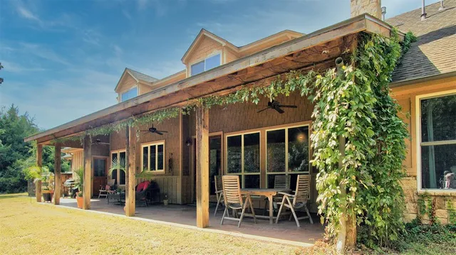 a view of a patio with table and chairs and potted plants