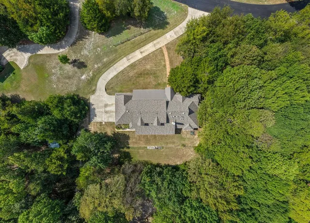 an aerial view of a house with a yard