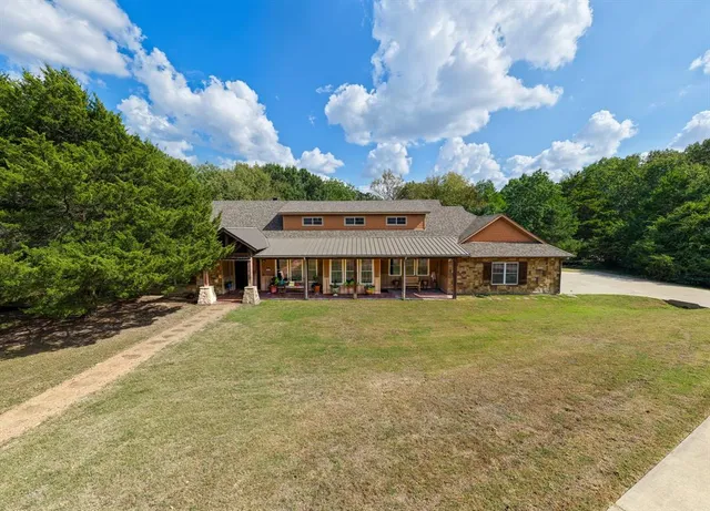 a view of a house next to a big yard