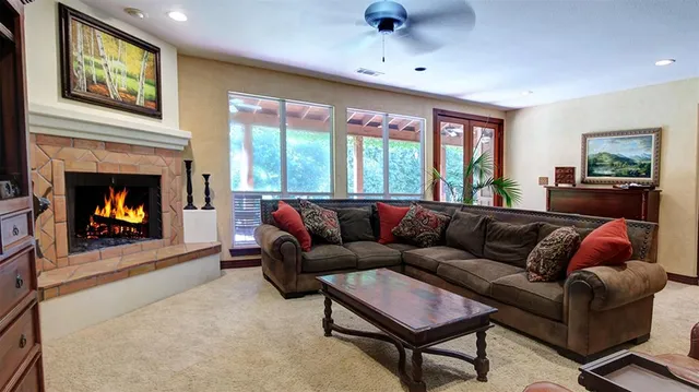 a living room with furniture and a fireplace