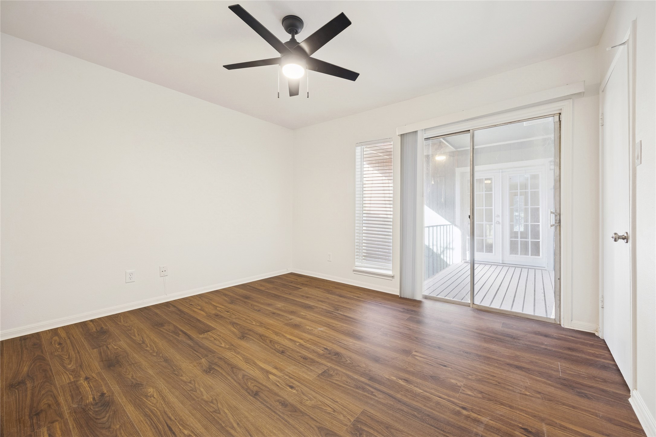 705 Harold Street, Unit 2 Houston, TX 77006 - Photo 12 of 15 an empty room with wooden floor and windows