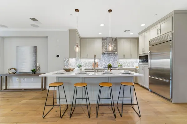 a kitchen with a sink a counter space appliances and cabinets