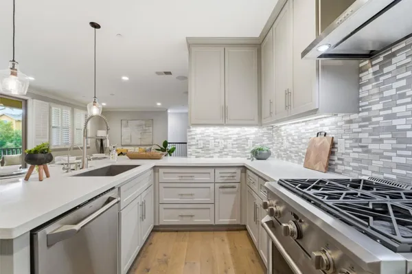 a kitchen with a sink stove and cabinets