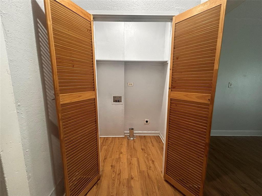 3615 Meadow Street Dallas, TX 75215 - Photo 13 of 15 Laundry room featuring washer hookup, light wood-style floors, a textured ceiling, and electric dryer hookup