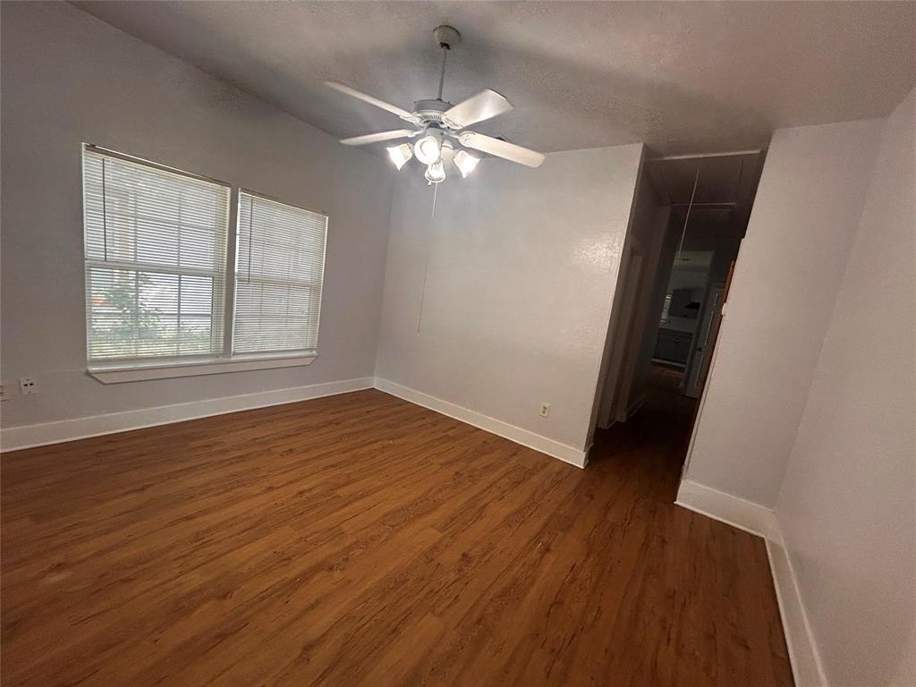3615 Meadow Street Dallas, TX 75215 - Photo 3 of 15 Unfurnished room with dark wood finished floors, attic access, and ceiling fan