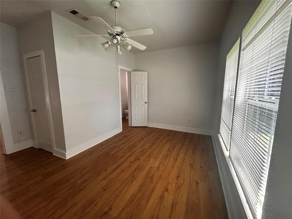 3615 Meadow Street Dallas, TX 75215 - Photo 7 of 15 Unfurnished bedroom with dark wood-style flooring, ceiling fan, and lofted ceiling