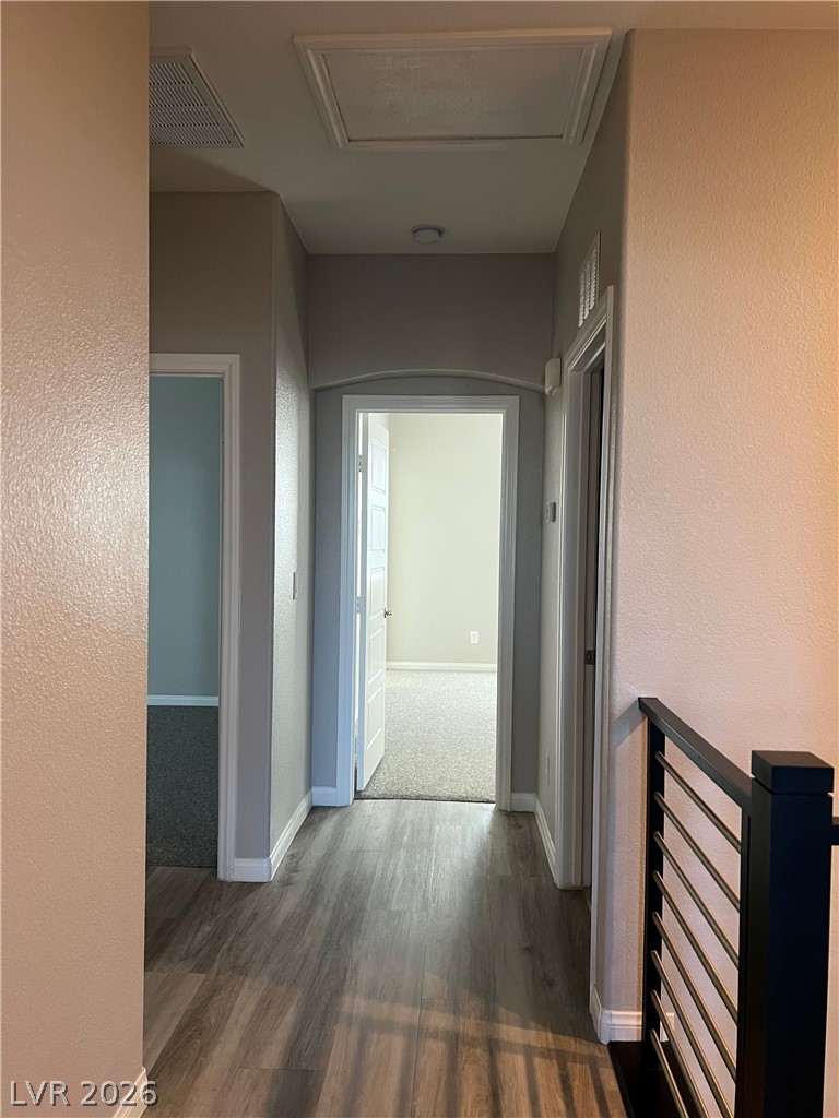 5981 Honeysuckle Ridge Street Las Vegas, NV 89148 - Photo 18 of 29 A well-lit hallway with durable wood-look flooring leads to multiple rooms.