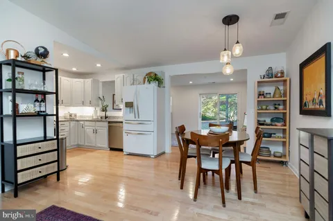 a view of a dining room with furniture and a kitchen