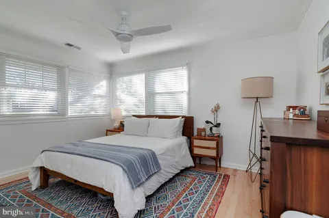 a bedroom with a bed and a lamp on table