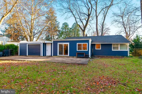 a front view of a house with a garden and yard