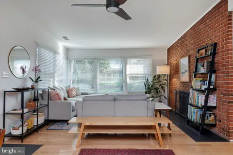 a living room with furniture and a floor to ceiling window