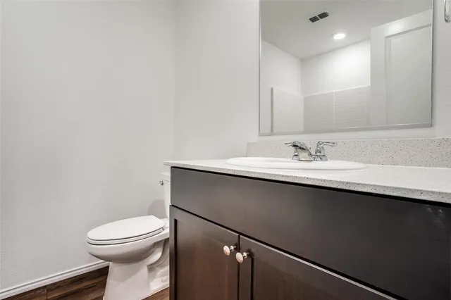 a bathroom with a sink a toilet and mirror