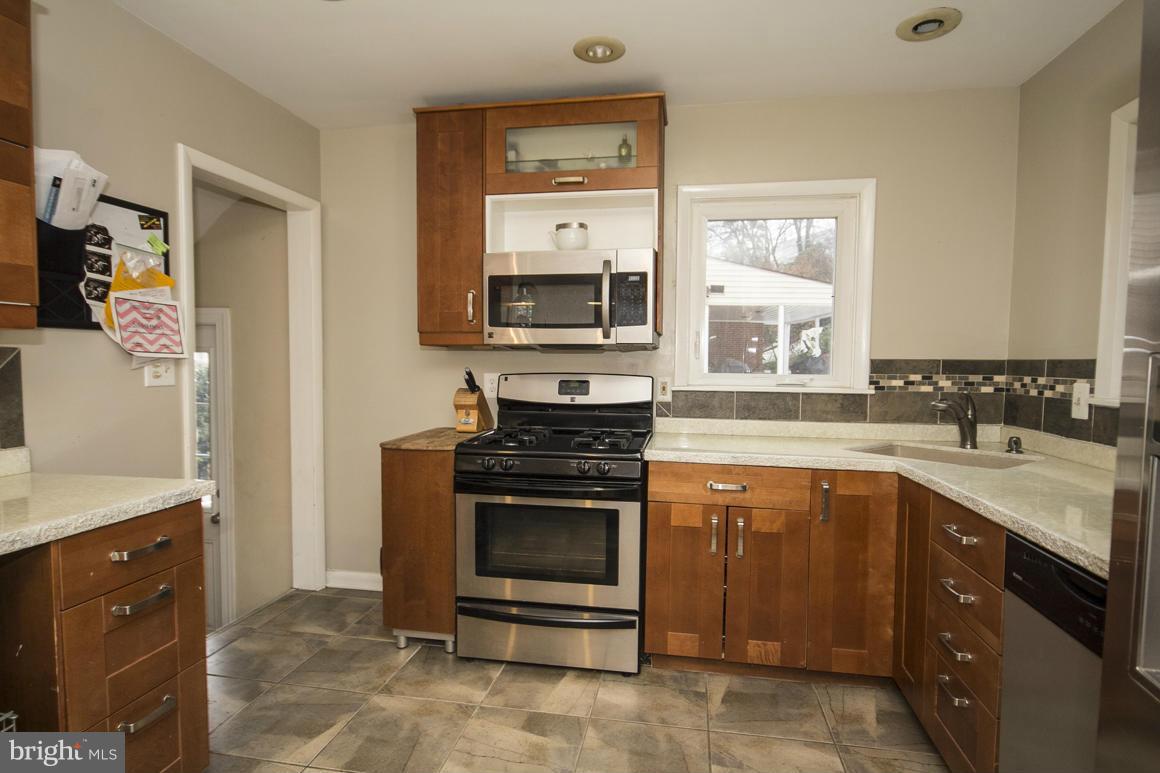 8216 Edwill Avenue Rosedale, MD 21237 - Photo 13 of 27 a kitchen with a stove and a sink