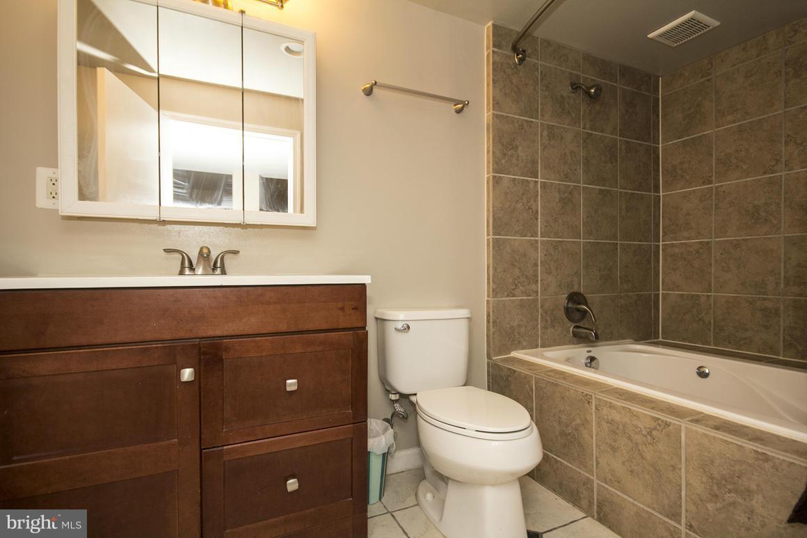 8216 Edwill Avenue Rosedale, MD 21237 - Photo 19 of 27 a bathroom with a sink toilet and shower