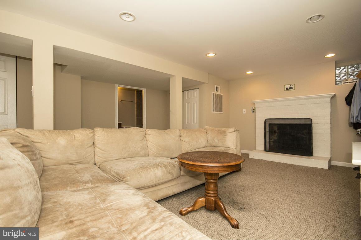 8216 Edwill Avenue Rosedale, MD 21237 - Photo 21 of 27 a living room with a couch and a fireplace