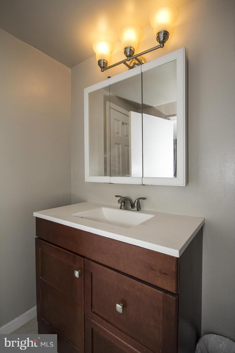 8216 Edwill Avenue Rosedale, MD 21237 - Photo 24 of 27 a bathroom with a sink vanity and a mirror