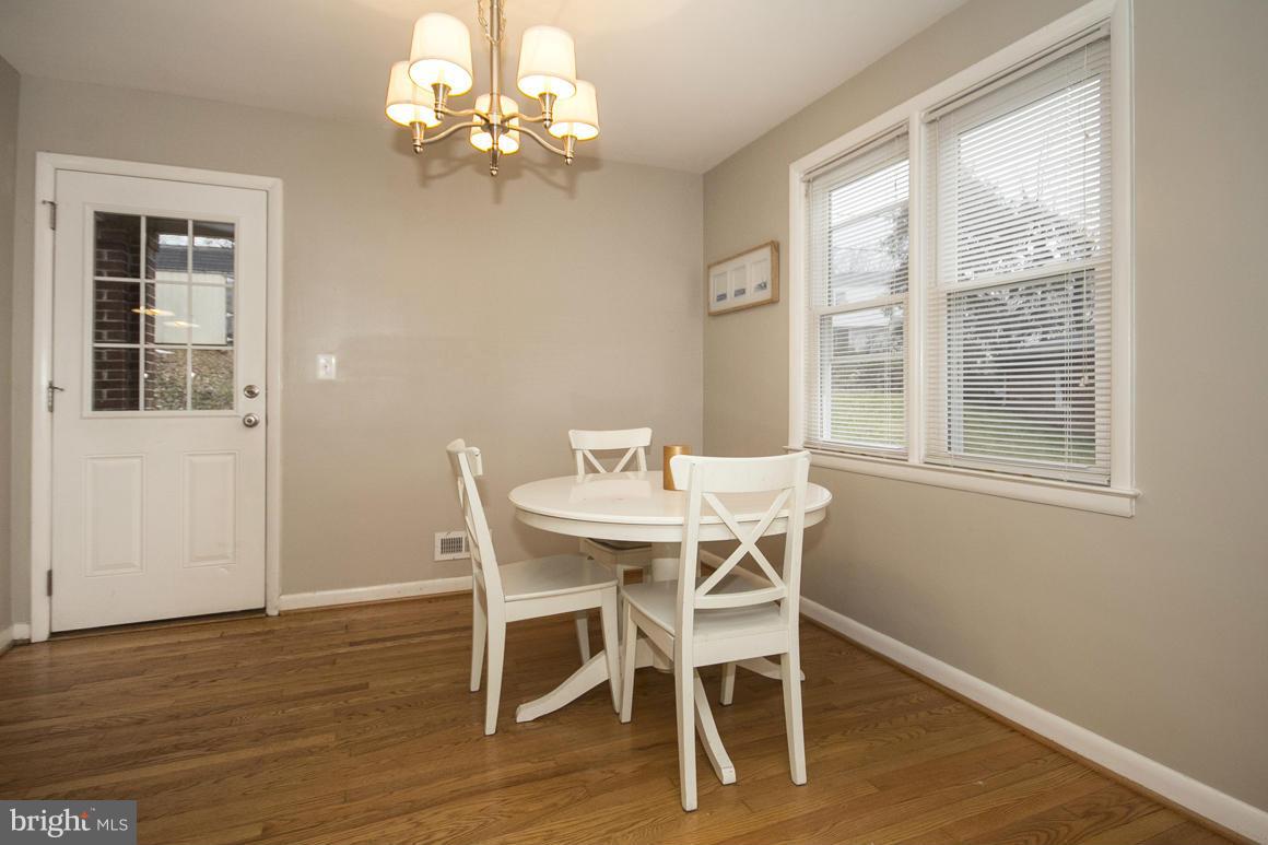 8216 Edwill Avenue Rosedale, MD 21237 - Photo 7 of 27 a view of a dining room with furniture a chandelier and wooden floor