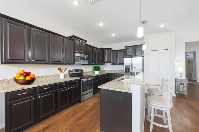 a kitchen with stainless steel appliances a sink stove and refrigerator