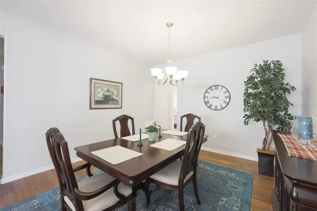 a view of a dining room with furniture and chandelier