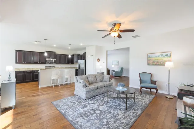 a living room with furniture and kitchen view