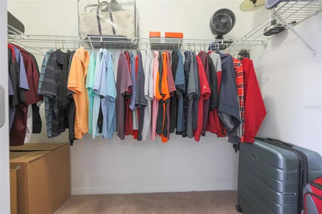 a view of walk in closet with clothes