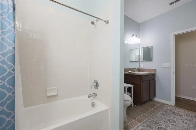 a bathroom with a sink a mirror and a bathtub