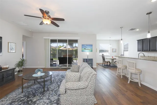 a living room with furniture a rug and a large window