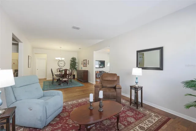a living room with furniture potted plant and a table